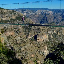 Marion on a suspension bridge of a side gorge